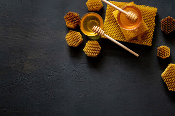 Healthy Thick honey dipping from the wooden honey spoon, bee products by organic natural...