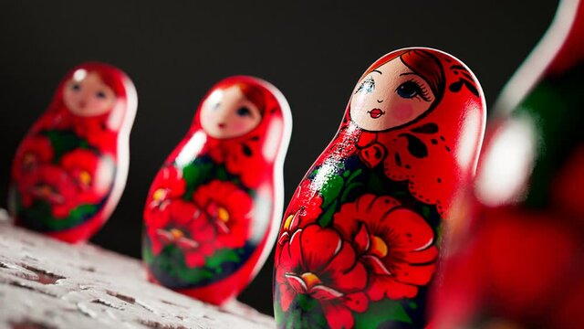 Matryoshka dolls placed in a circle. A camera follows one babushka after another