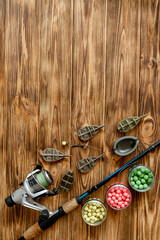 Accessories for carp fishing and fishing baits on wooden planks with copy space
