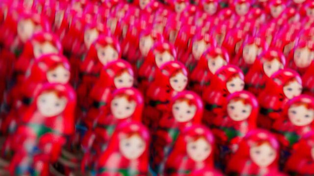 Rows of red matryoshka nesting dolls with camera zoom and motion blur