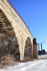 Vintage and historic city stone bridge over the river in winter