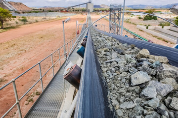 A closeup shot of platinum rock being moved on a conveyor belt