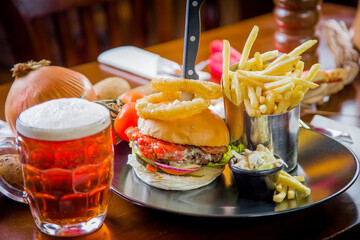 burger and fries with beer