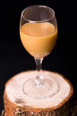 egg liqueur in a glass on wood