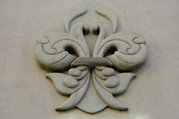 fleur de lis sculpture on a wall downtown