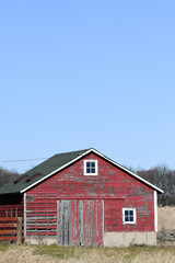weathered red barn in the country