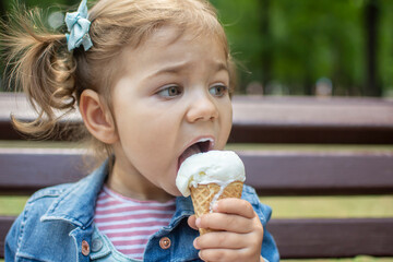 Cute adorable baby girl eating icecream. Funny child joining İce cream. Pretty toddler girl holding desert.