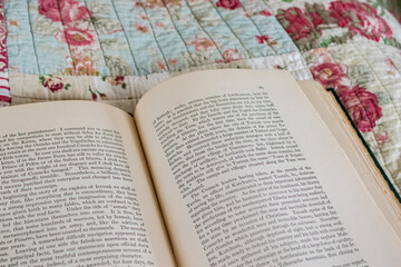 Open Old Book Lying on A Quilt