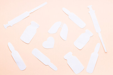 lungs and heart symbols near medicaments isolated over pink background. medication concept. syringe,vial,ampoule shapes made paper