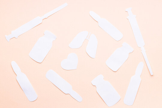 lungs and heart symbols near medicaments isolated over pink background. medication concept. syringe,vial,ampoule shapes made paper