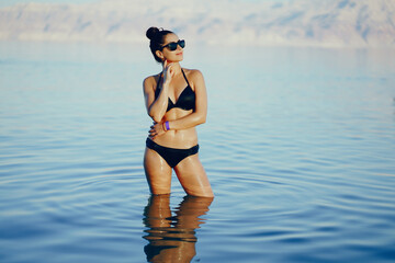 brunette girl swimming in the dead sea in israel