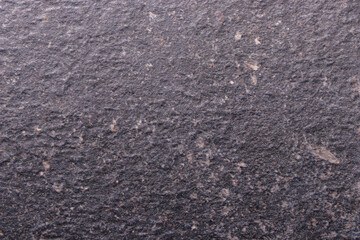 Grey scuffed background imitating the surface and texture of a stone. Empty background.