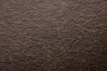 Brown scuffed background imitating the surface and texture of a stone. Empty background.
