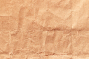 Fototapeta premium Texture of crumpled beige craft paper. Empty background.