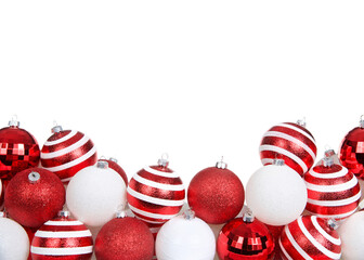 red white and striped Christmas tree ornaments piled decoratively in a row isolated on white...