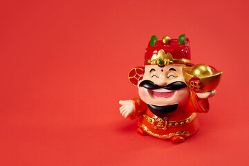 God of wealth holding gold ingot, Chinese text translation: gold and wealth