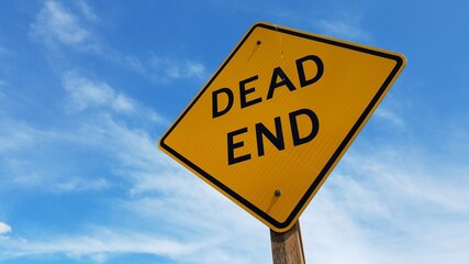 Dead End signage with clear blue sky background