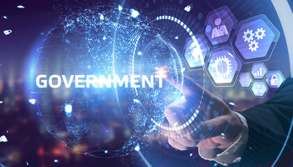 Fototapeta premium The concept of business, technology, the Internet and the network. A young entrepreneur working on a virtual screen of the future and sees the inscription: Government