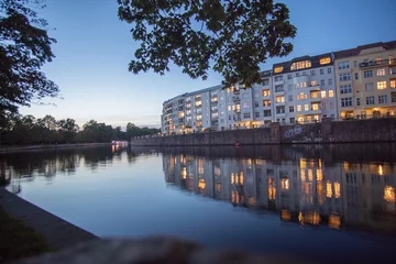 Fototapeten apartments in the sunset at the river in the near of berlin castle park © Danny