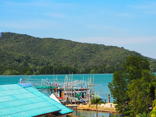 Fototapeta premium Fishing boats moor to fish by the sea and in the surrounding mountains