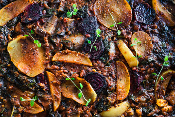 plant-based food,  vegan veggie roast with potatoes beetroot and kale as main ingredients