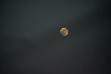 Moon over gray clouds 