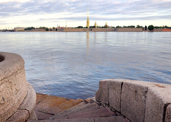 Descent to the Neva. Granite parapet with stairs on the Palace embankment, view of the Peter and...