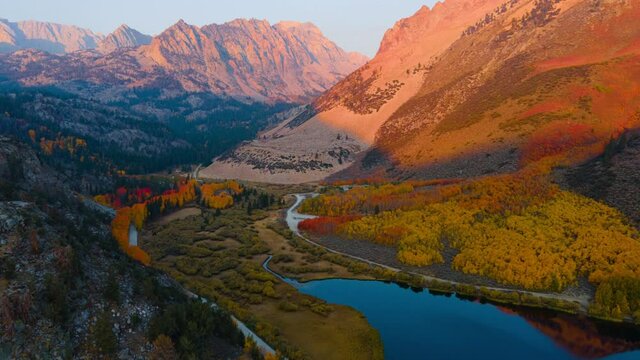 Aerial hyperlapse of colorful fall foliage at sunrise over North Lake in Eastern Sierra Nevada mountains in California