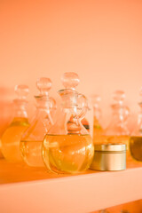 Fragrances in the glass bottles on the shelves. Liquid oils and perfumes in big bottles. Crafts supplies.