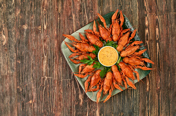 Crayfish-boiled river crayfish on a dark wooden background.Space for text.
