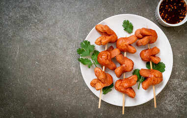 fried sausage skewer with dipping sauce
