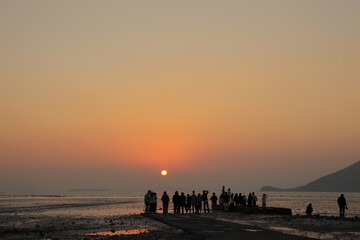 A fishing village landscape at sunset scenery. People watching the sunset. Waon Beach Suncheon South Korea. Nov. 17, 2020.