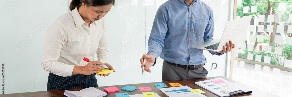 Poster businessman stick colorful notes to brainstorming on the table working on new project to share idea 