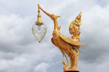 Golden hongsa sculpture in Thailand on cloud background golden swan statue