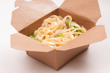take away container with chicken fetuccine alfredo primavera