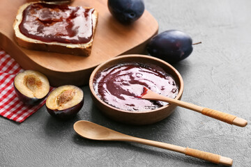 Composition with delicious homemade plum jam on table