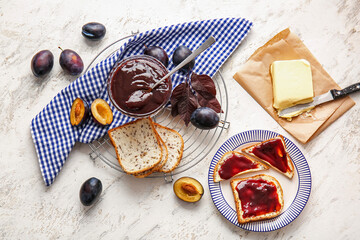Composition with delicious homemade plum jam on table