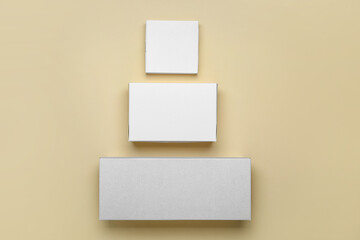 Blank cardboard boxes on color background