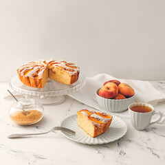 Dessert stand with tasty peach pie on table