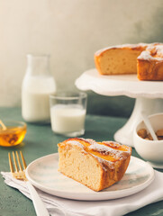 Plate with piece of tasty peach pie on dark background