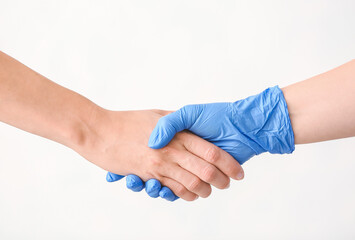 Doctor and patient shaking hands on white background