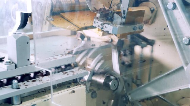 Factory machine is packing chocolate sweets