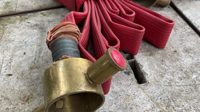 Red fire hose on concrete