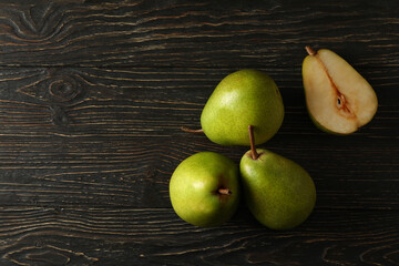 Fresh green pears on wooden background, space for text