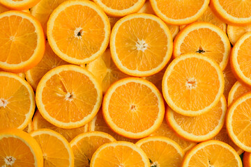 Texture of sliced orange, fresh and healthy fruit, which is rich in juice and vitamin c. Orange background.