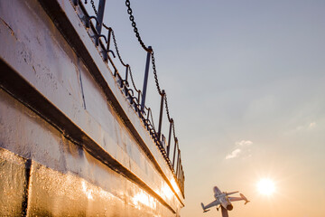 The old rusty battleship and war plane with blue sky.