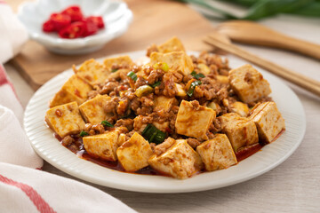 Mapo tofu, stir-fried tofu with hot spicy sauce in white plate.
