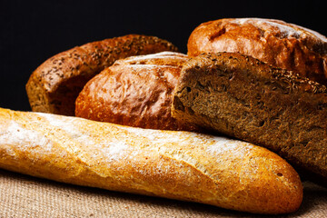 Bread counter at the bakery. Freshly baked bread is on the counter. Dark background, rustic style.