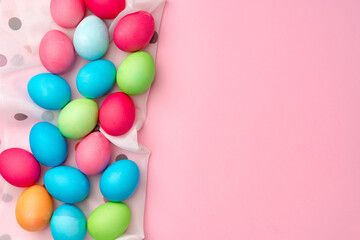 Fototapeta na wymiar Painted Easter eggs on pink background top view