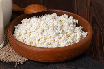 Bowl of cottage cheese on wooden table